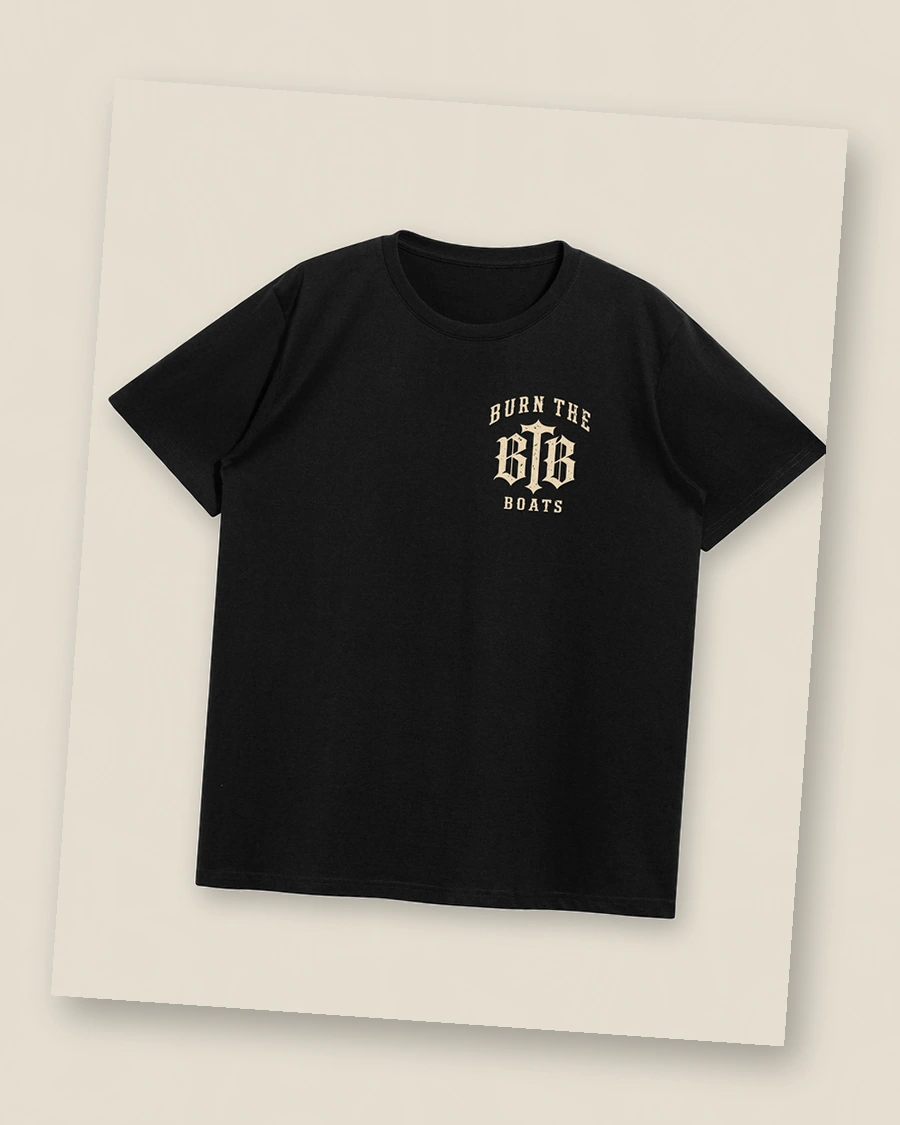 Angled view of The Gods Don’t Spot You washed-black T-shirt with approved artwork placement